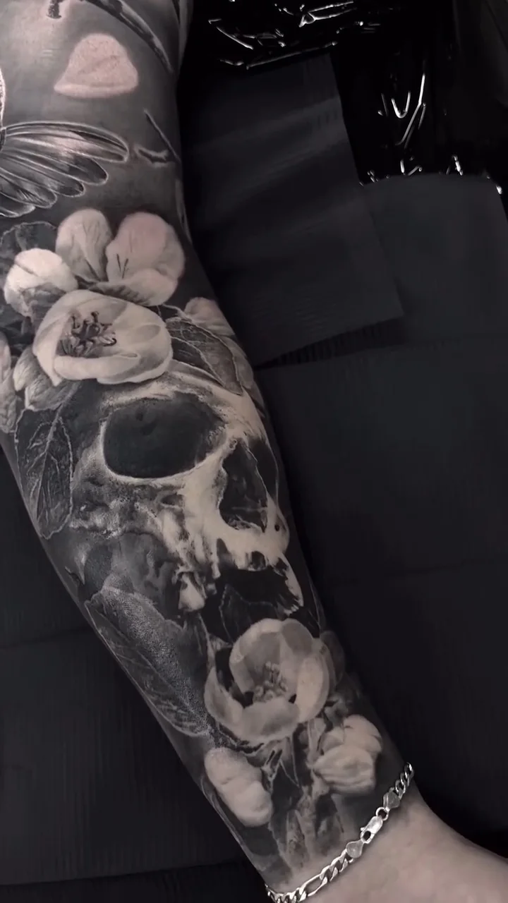 a skull among open flowers, wrapping the full sleeve, STYLE tattoo by ARTIST NAME, NEIGHBOURHOOD CITY