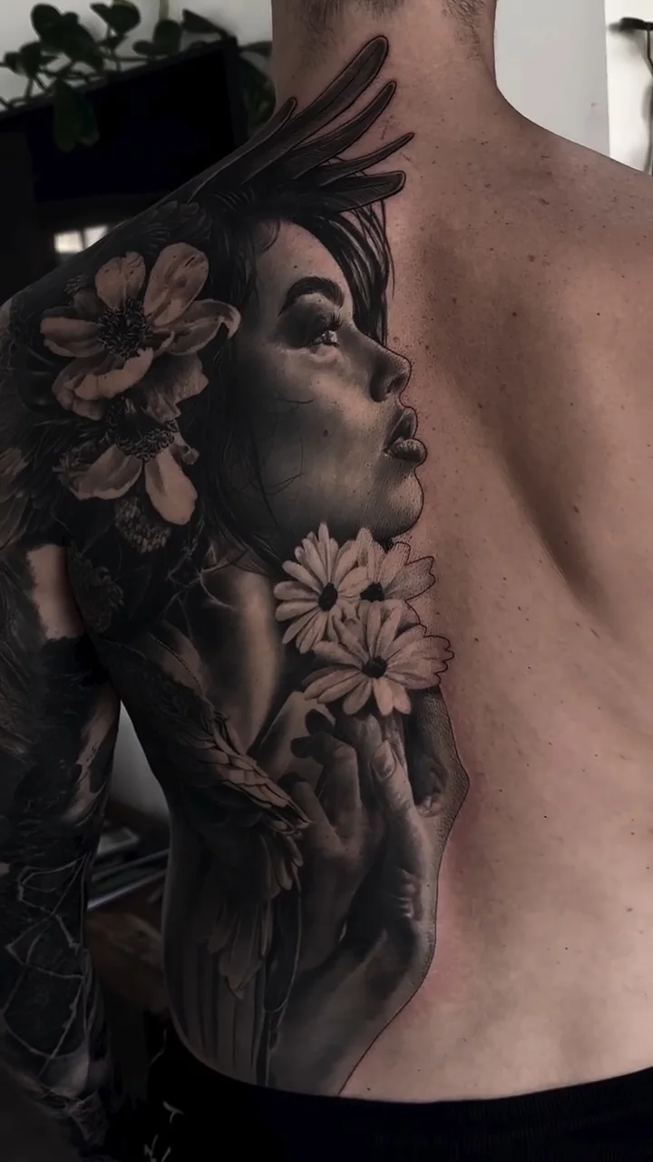 a woman's portrait among daisies and blossom, along the ribs, STYLE tattoo by ARTIST NAME, NEIGHBOURHOOD CITY