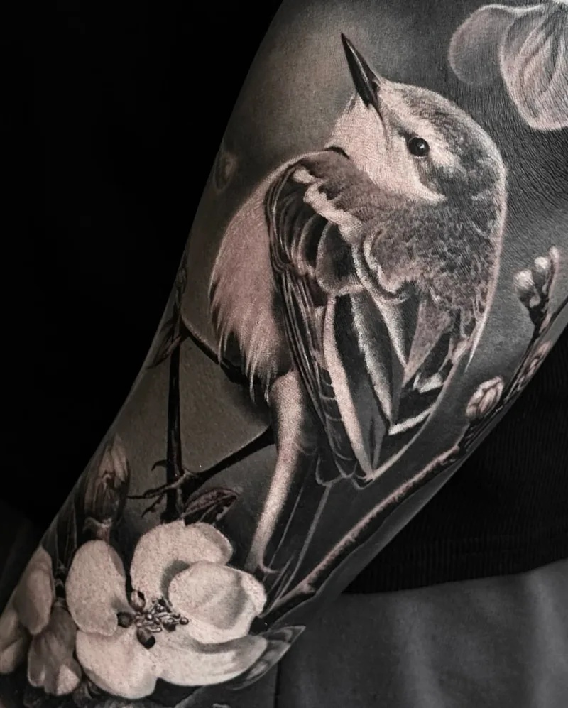 a jay perched among blossom on the forearm, STYLE tattoo by ARTIST NAME, NEIGHBOURHOOD CITY