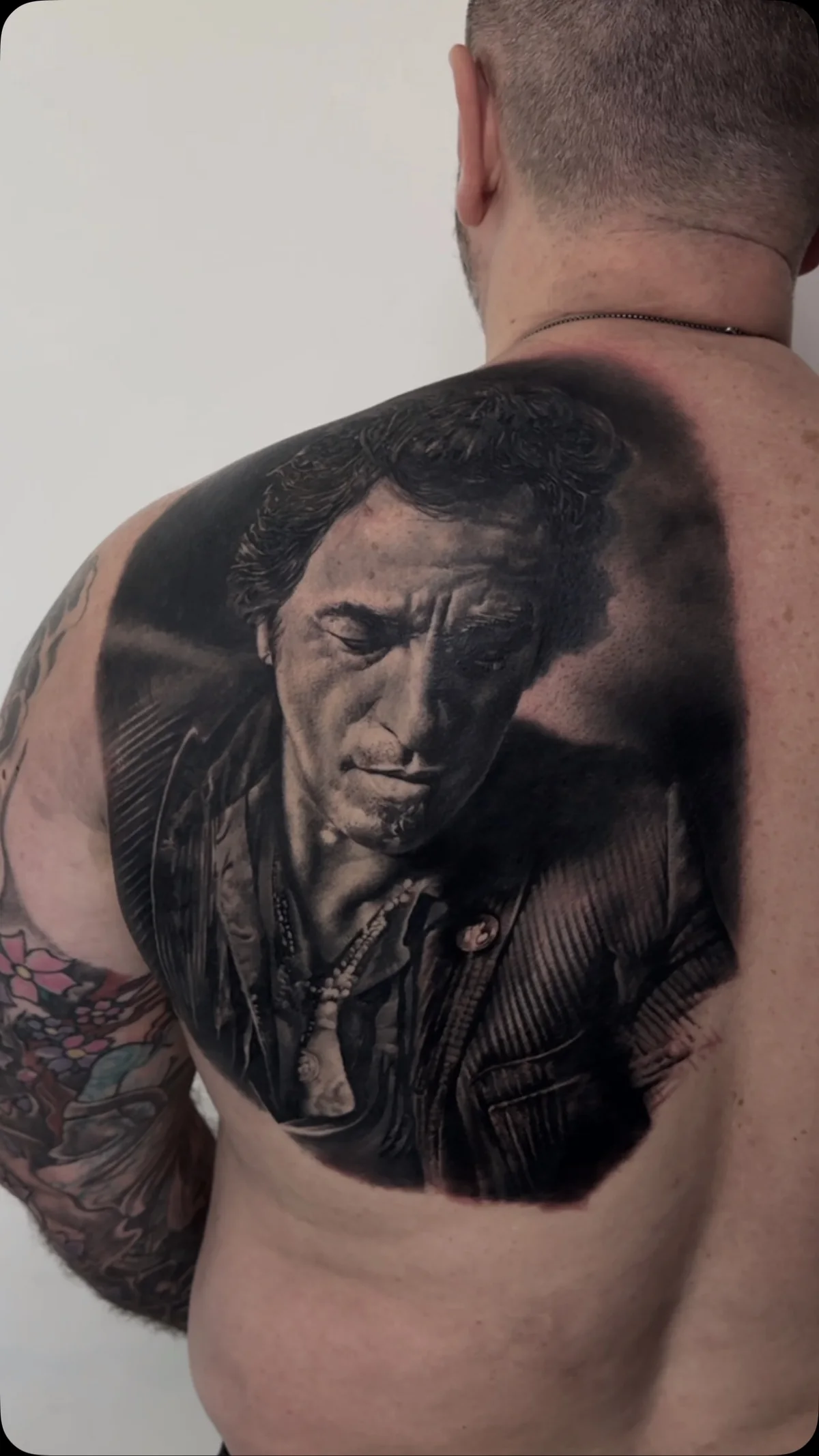 a boxer's portrait across the shoulder blade, STYLE tattoo by ARTIST NAME, NEIGHBOURHOOD CITY