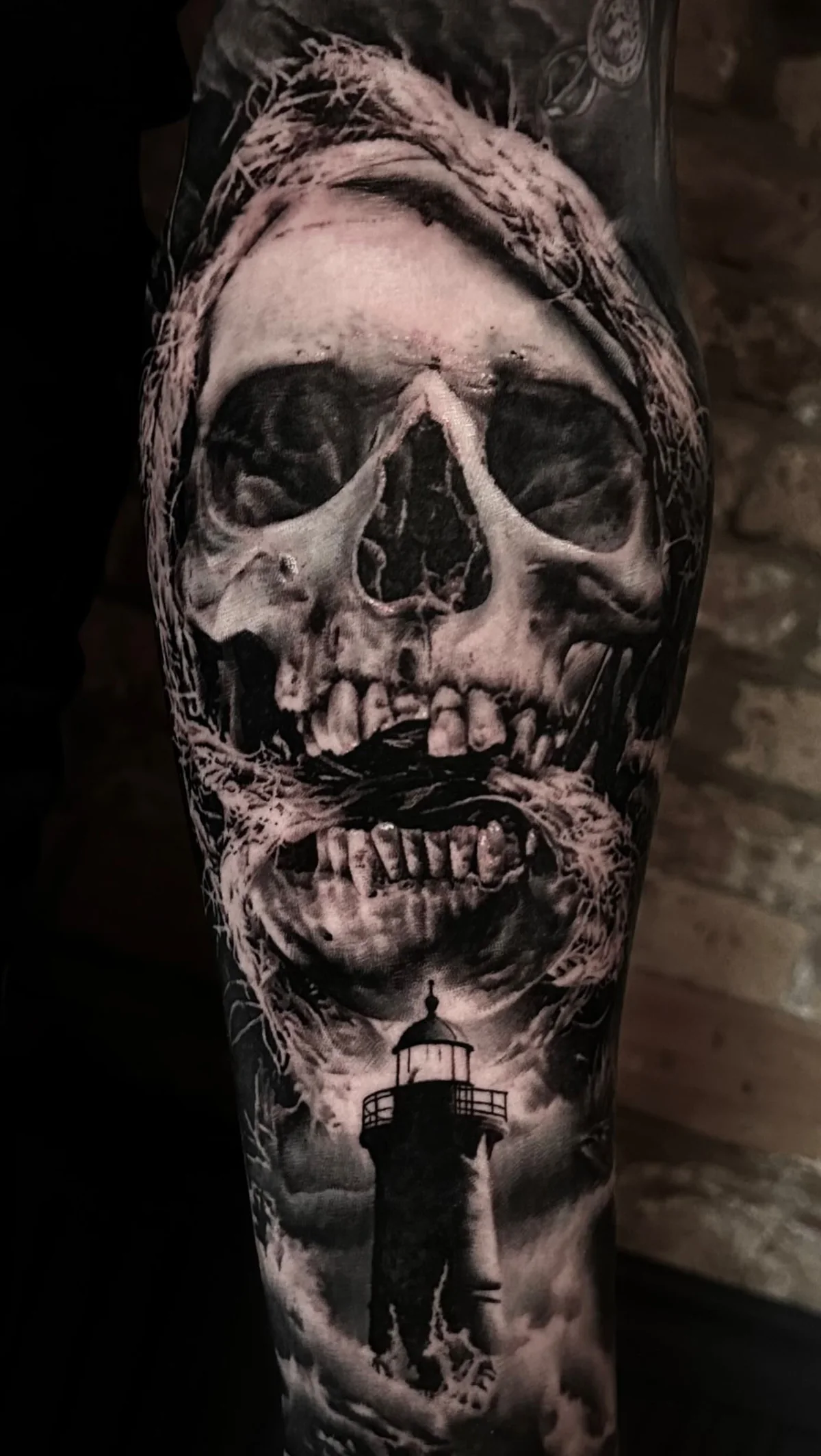 a skull beneath a heavy hood, with a lighthouse below, STYLE tattoo by ARTIST NAME, NEIGHBOURHOOD CITY