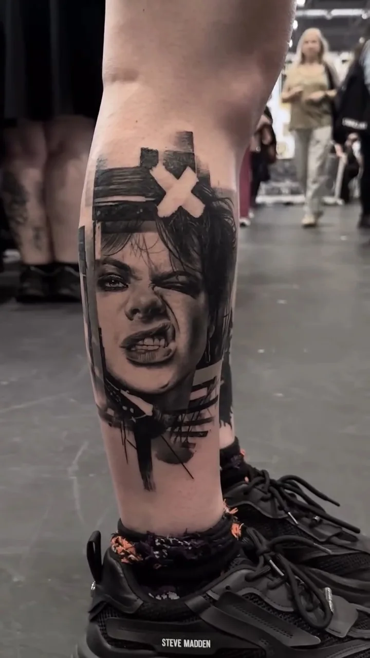 a snarling portrait struck through with a white cross and torn panels, black and grey realism tattoo by Victor Armero, Plymouth