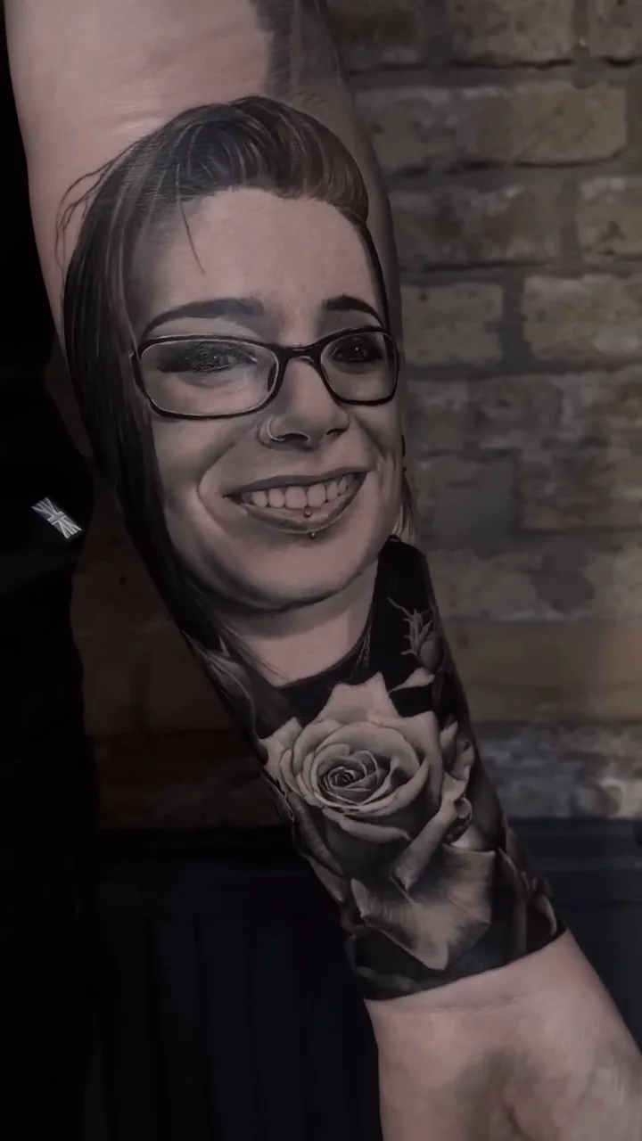 a smiling portrait of a woman in glasses, beside a rose, STYLE tattoo by ARTIST NAME, NEIGHBOURHOOD CITY